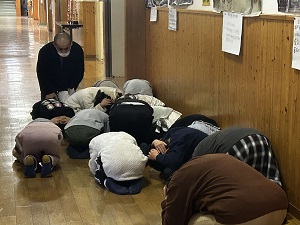 児童が屋内で避難体制を取る写真